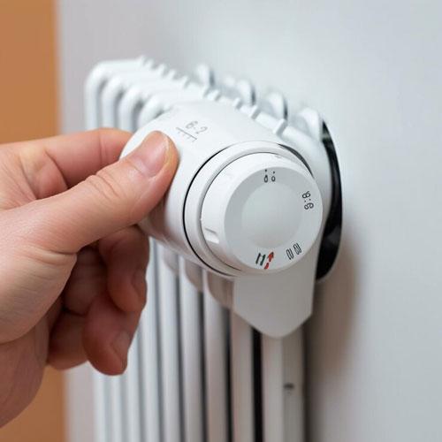 qualcuno-sta-girando-la-manopola-di-un-radiatore-elettrico-bianco-generativo-ai_958165-56535 RADIATORI - Impianti tecnologici per la casa - ENERGEO Srl Sassari